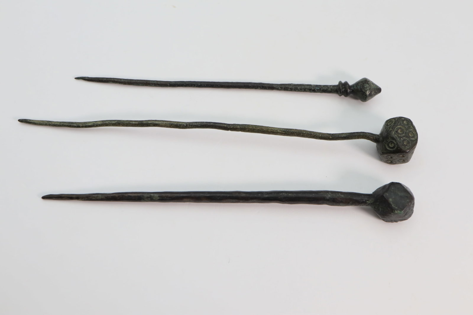 Migration Period Hair Pin Collection, Circa 6th, 7th Century AD: Collection of three bronze hair pins with pointed ends; 92.10mm, 82.50mm and 72.40mm length, 15.48 grams in total. Fine condition. From the collection of London gentleman.