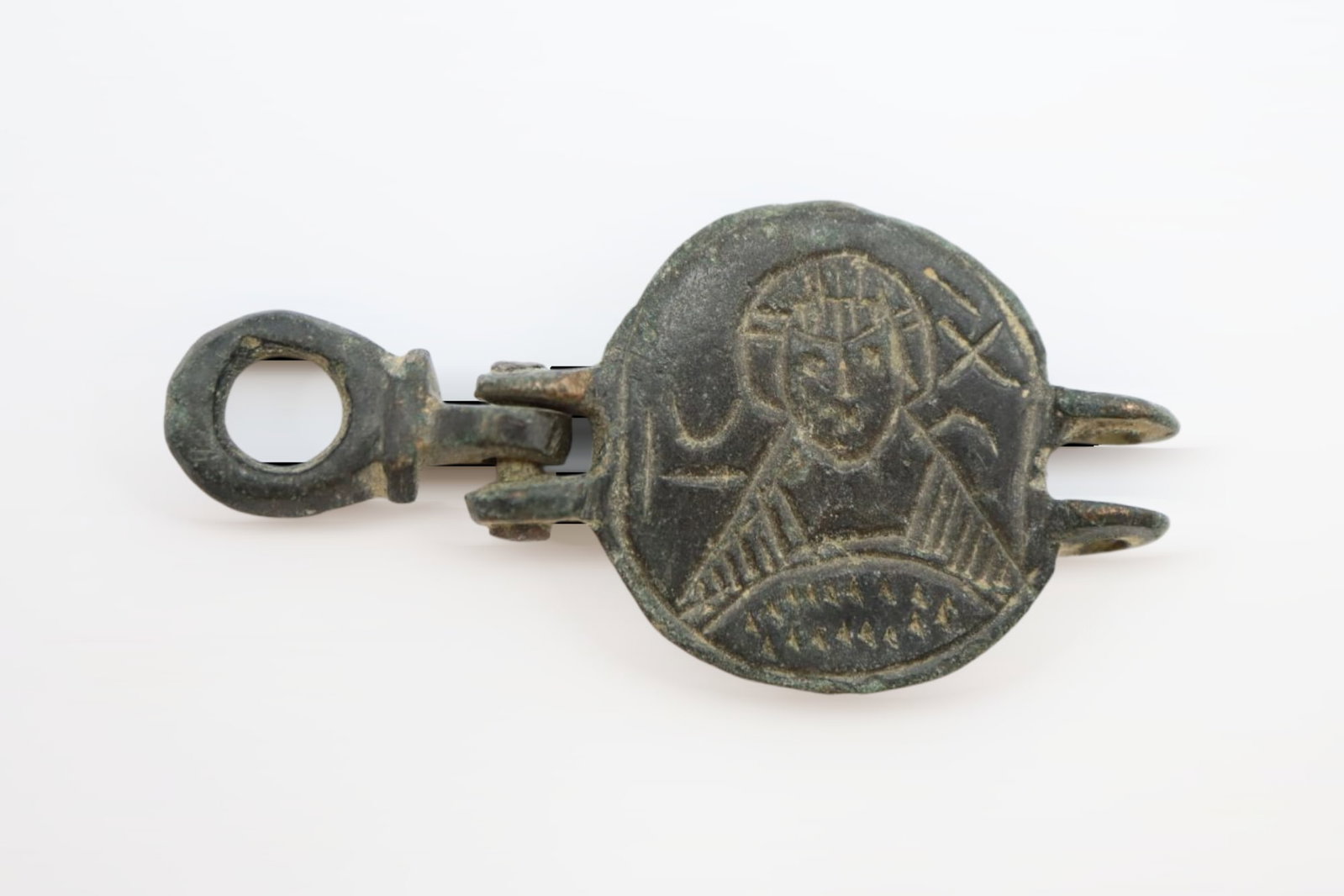 Byzantine Bronze Pendant with Christ , Circa 11th-12th century AD: Byzantine bronze pendant with a hinged loop and image of a Christ or a Saint; Greek alphabet ; 9.50 grams, 43mm. Fine condition. From the collection of a London gentleman, acquired on the UK art marke