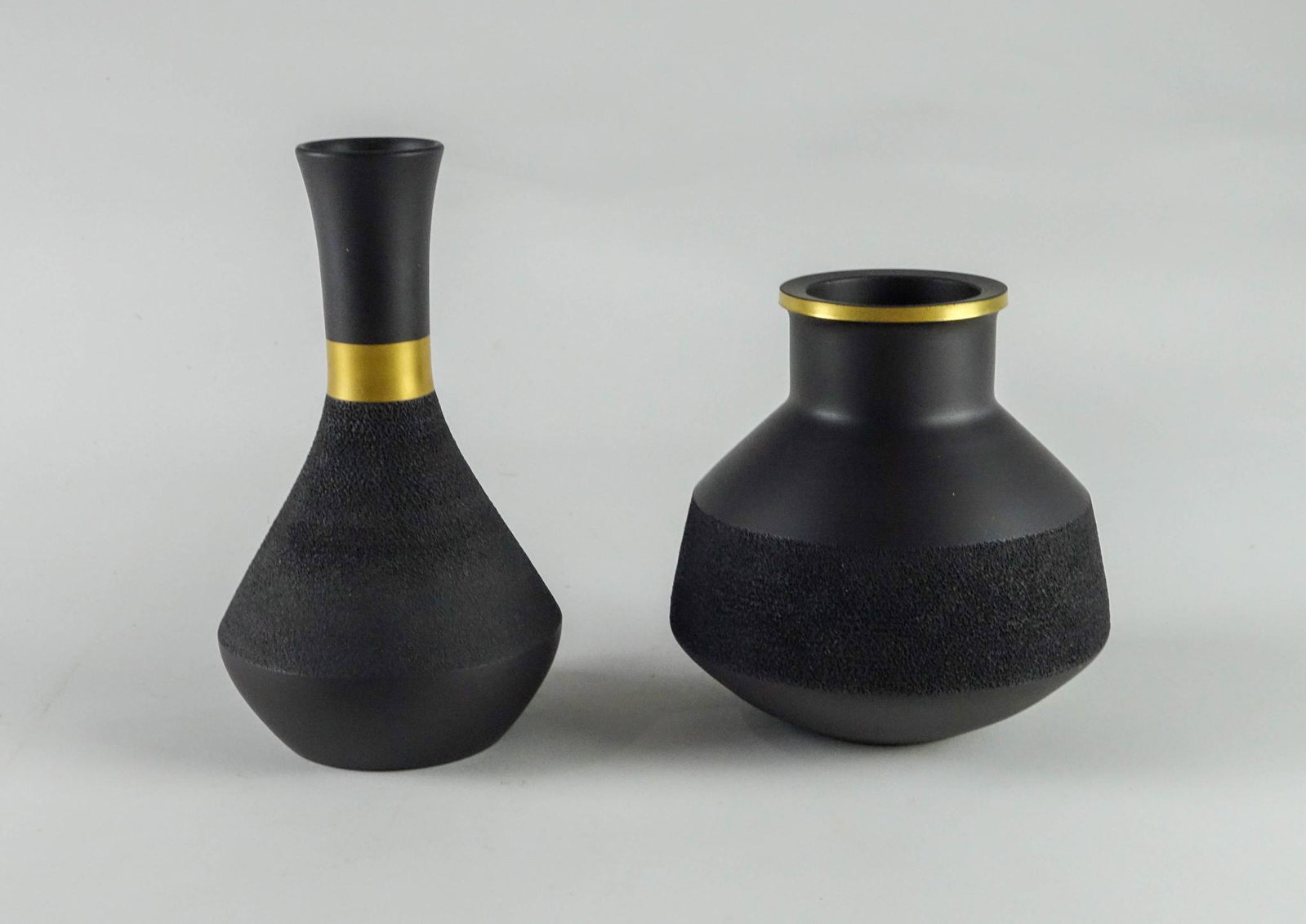 Two Wedgwood Black Basalt Vases.: Heights 6 and 7.5 inches. Condition reports are not available for the items in this catalog. These are antique and vintage items, and will show signs of use and wear. We have attempted to show any obv