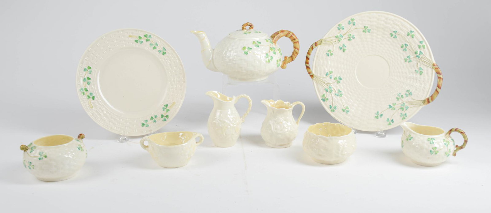 Nine Pieces Belleek Pottery.: Two plates, teapot, and more. Condition reports are not available for the items in this catalog. These are antique and vintage items, and will show signs of use and wear. We have attempted to show any