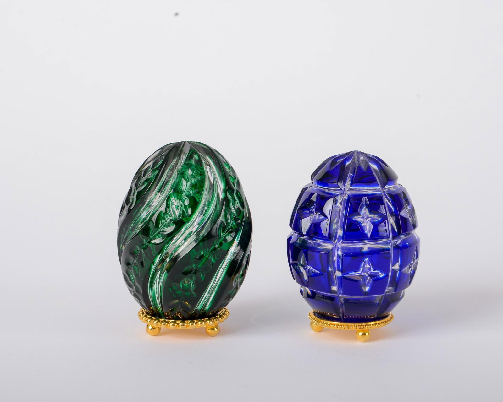TWO SMALL COLORED GLASS FABERGE EGGS. (1 of 3)