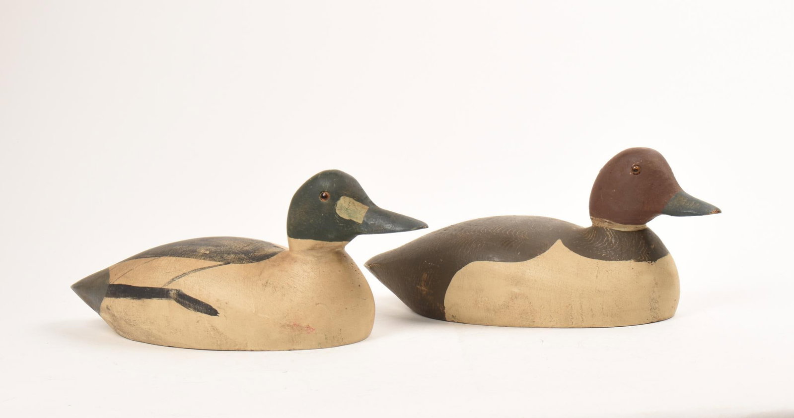 PAIR OF WHISTLER DUCK DECOYS: New England circa 1940-1950, length 13 inches