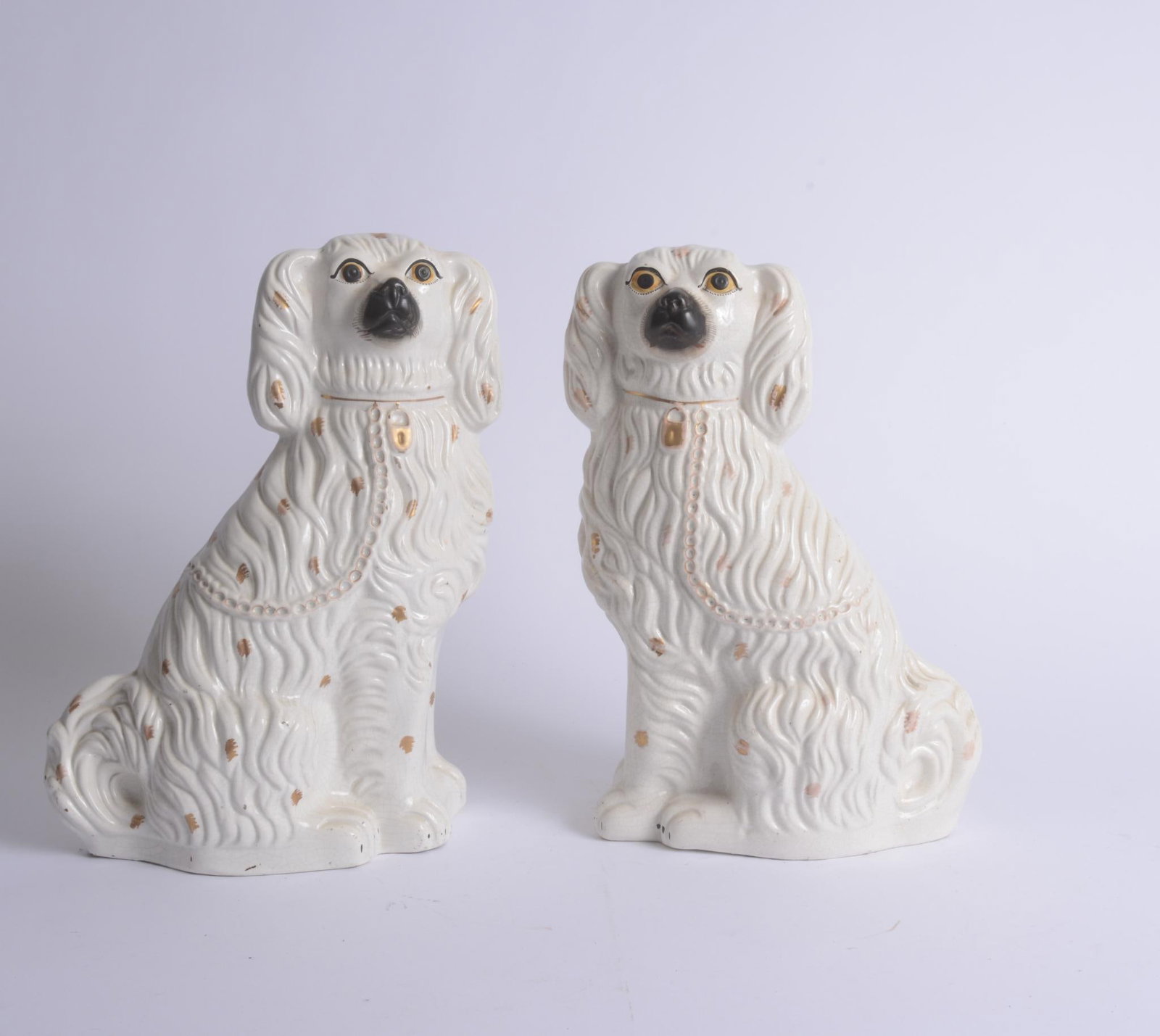 PAIR OF LARGE STAFFORDSHIRE DOGS: Cream colored with gold decoration, height 15 inches, good condition