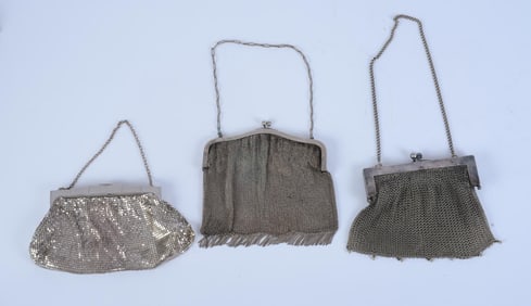 THREE SILVER MESH EVENING PURSES.