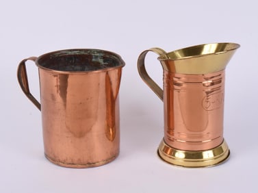 TWO OVERSIZED COPPER PITCHERS.
