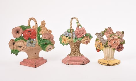 3 CAST IRON PAINTED PINK AND YELLOW FLORAL DOORSTOPS