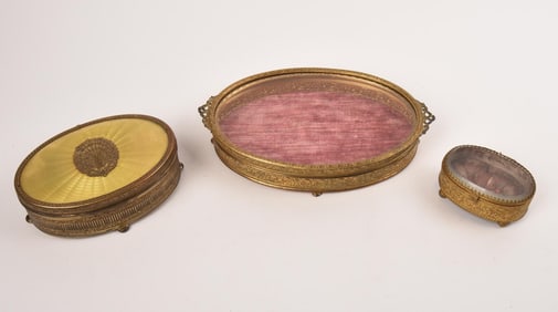 THREE GILT METAL AND GLASS DRESSER BOXES.