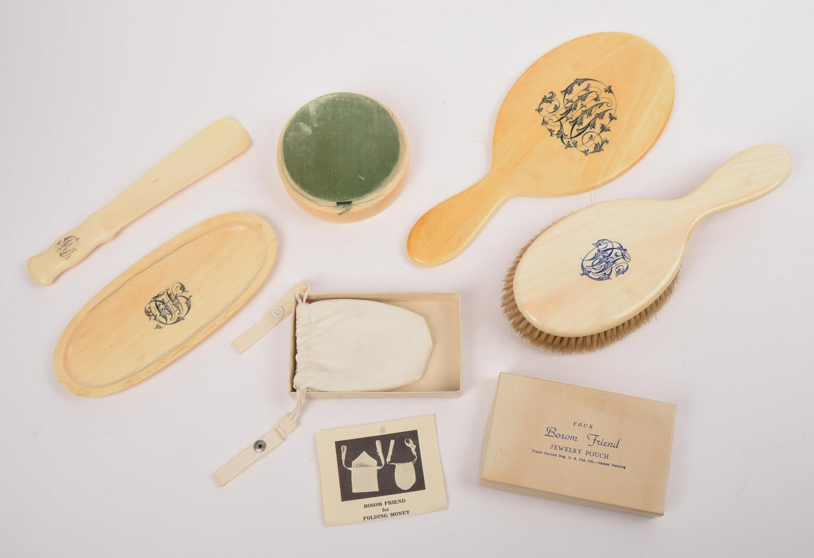 TIFFANY & CO DRESSER SET.: Brush, length 10 inches, mirror, dresser box, shoe horn, and a tray. Together with a Bosom Friend Jewelry Pouch.