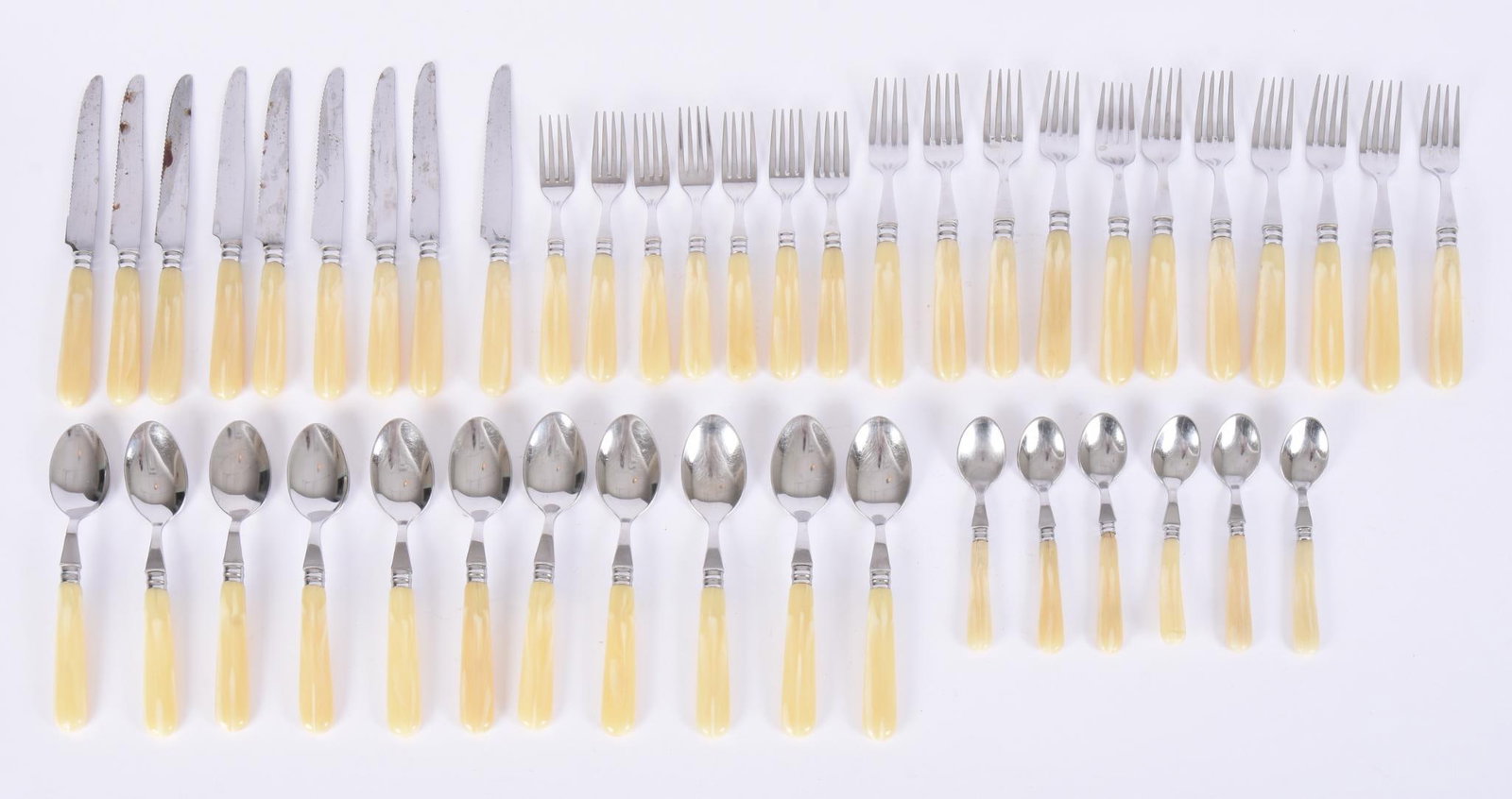 French Stainless Steel and Bone Style Handle Flatware: Including 11 soup spoons, 9 knives, 18 forks and 6 spoons, length of knives 9.5 inches