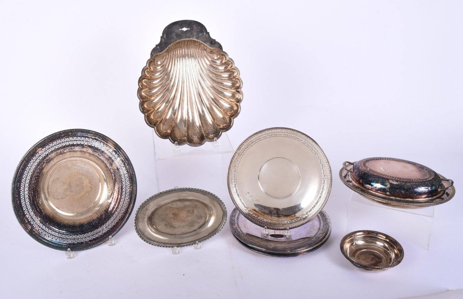 Group of Silver Plate Serving Items: Including 4 Reed and Barton plates, shell dish, covered dish, pierced bowl, wine coaster and oval dish, shell dish length 13.25 inches