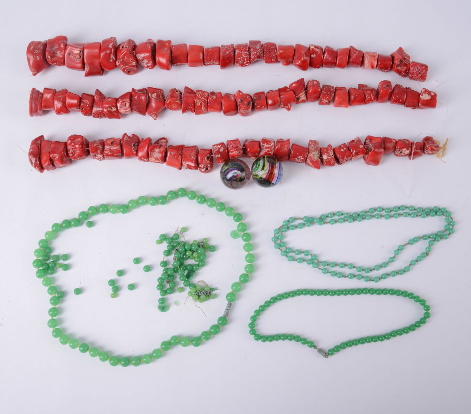 Three Green Stone Necklaces: With 3 strands of large red stone beads and 2 marbles, 1 green necklace loose.