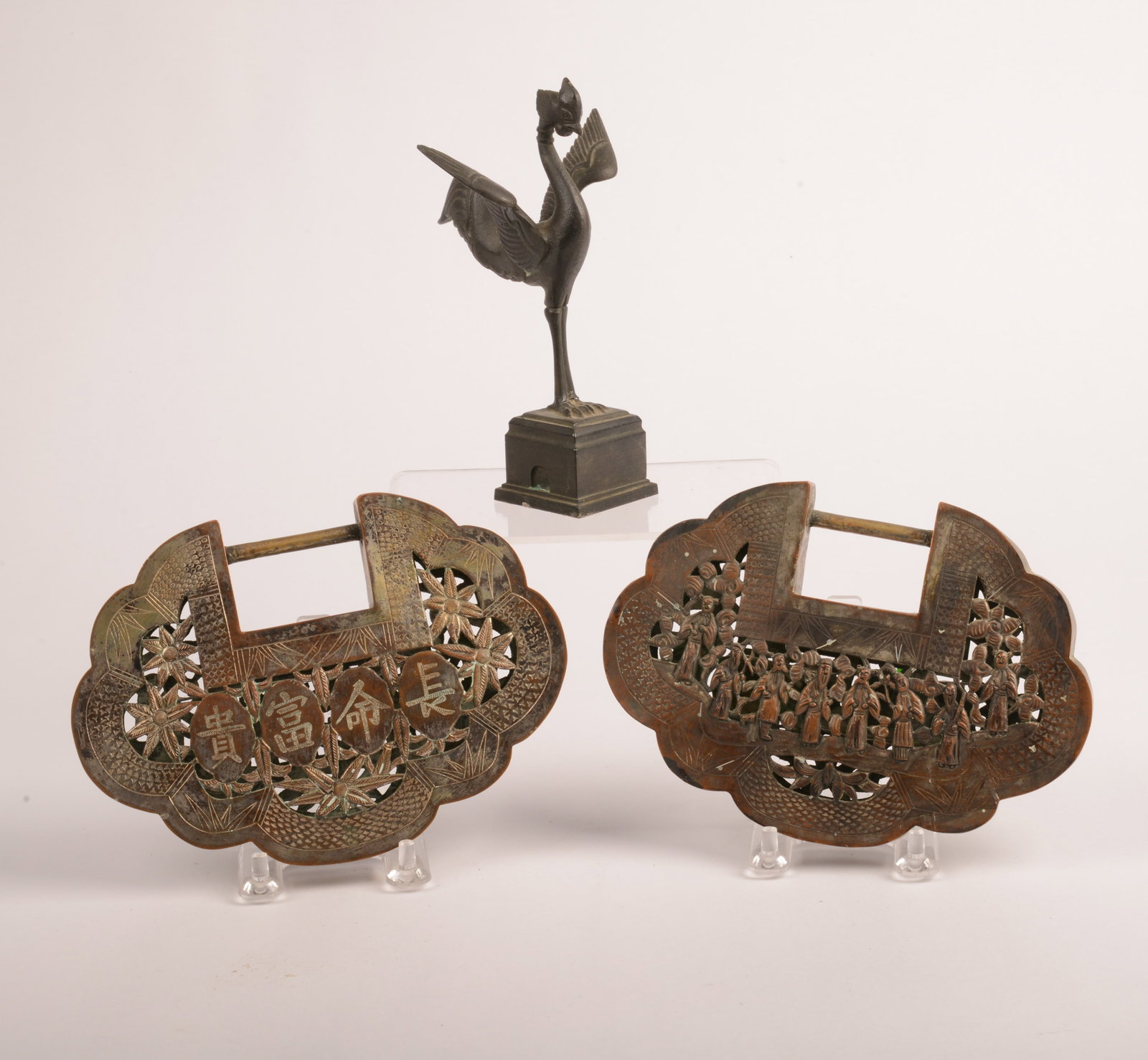 Pair of Chinese Carved Metal Kirinsongzi Locks: With Asian metal bird on stand, width of locks 6.75 inches.