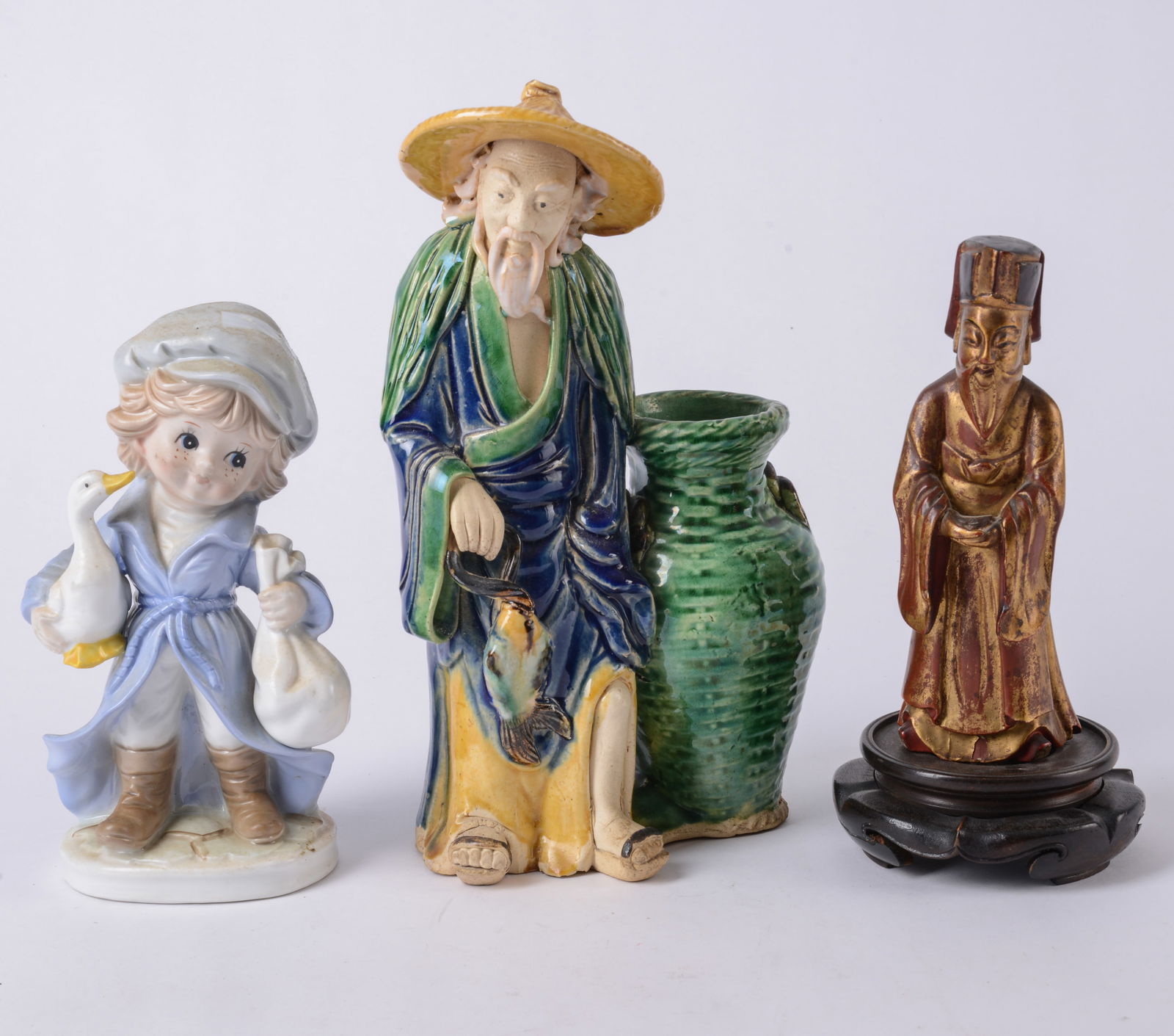 KPM Figure of a Girl with Asian Figure with a Vase: And carved wood Asian male figure, height of KPM 7.5 inches, vase with rim chip.