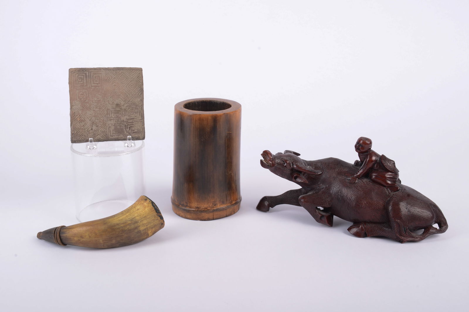 Carved Wood Asian Bull With Figure on It's Back: With wood brush pot, horn and clay tile, height of bull 4 inches.