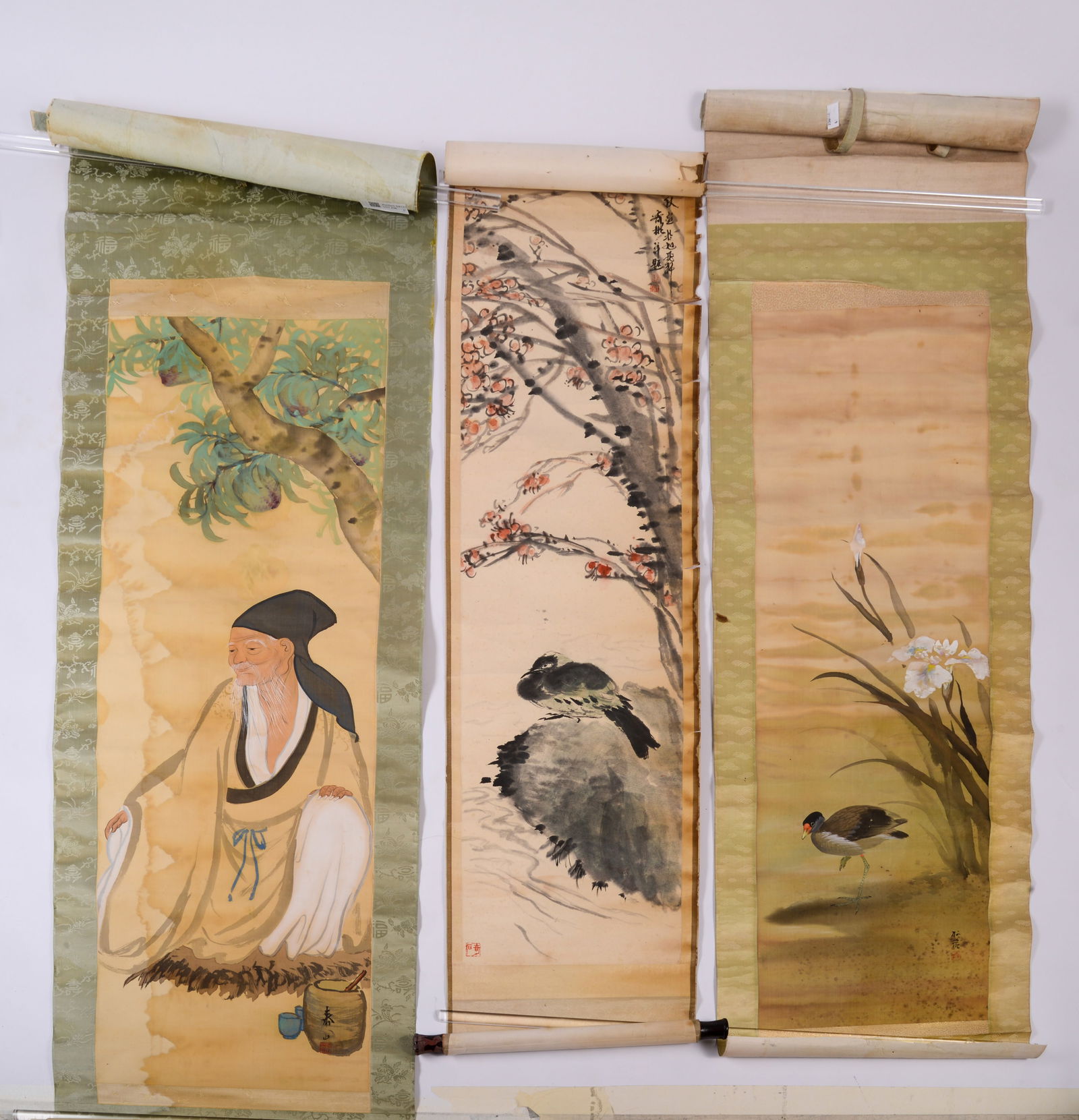 Chinese Scroll of Wise Man Under Tree, With Green Trim: Together with scroll of bird by grasses, and scroll with bird under flowering tree, edges torn. Wise man scroll length 75 inches. Tears and staining.