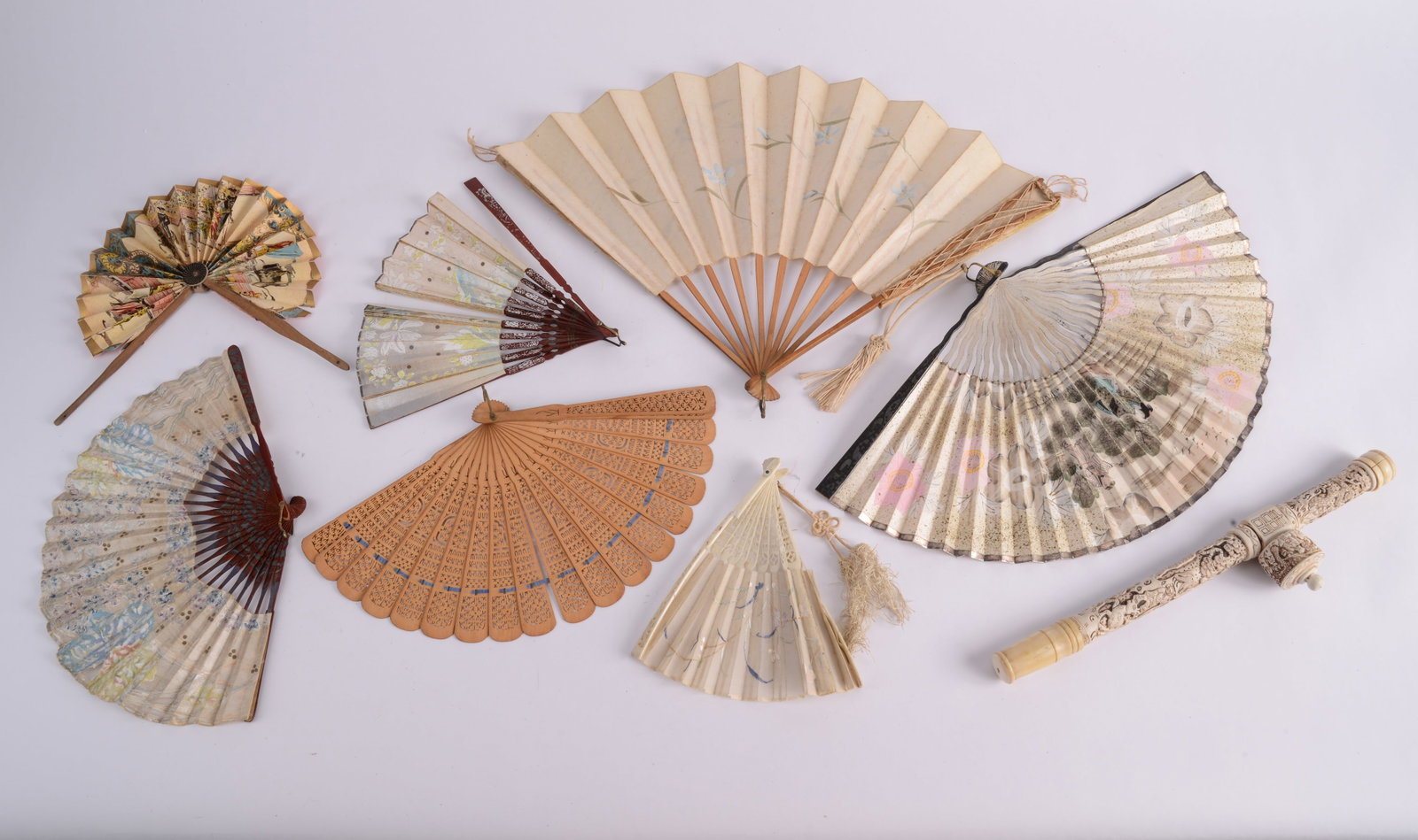 White Carved Pipe and Seven Hand-Held Fans: Six paper fans, one wood. Length of pipe 14.5 inches. Two fans ripped