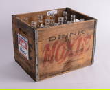 Twelve Glass Moxie Soda Bottles in a Moxie Wood Crate