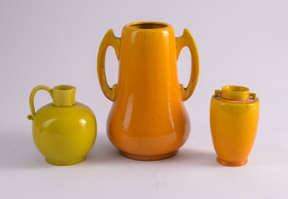Two Orange Ceramic Vases and a Yellow Ceramic Pitcher.