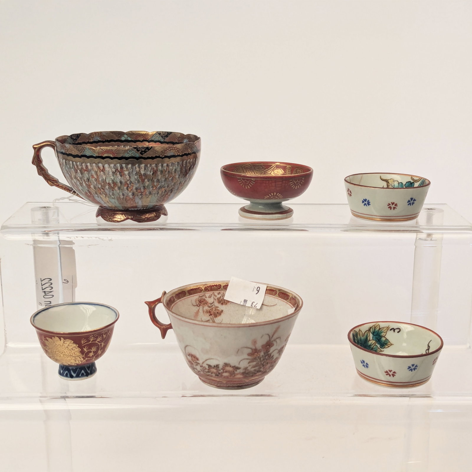 Group of Asian Finely Painted Teacups and Cups: Including pair with figures painted on bottom, 2 footed cups and 2 teacups, largest cup height 2 inches, good condition.