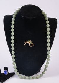 Jade Necklace, Costume Jewelry Brooch, and a Ring.