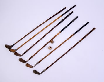 Six ANtique Golf Clubs and Two Balls.