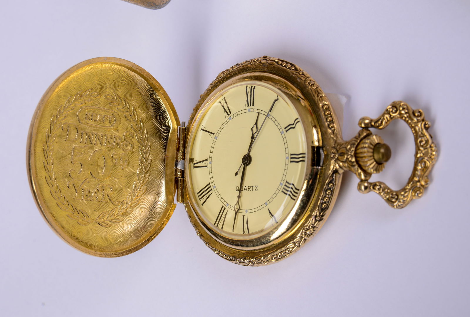 Bulova Quartz Clock in Wood Box Inscribed JL Kraft 90th Anniversary: With Kraft pocket watch, lighter, Armitron watch and other desk accessories. Bulova clock diameter 3.5 inches.