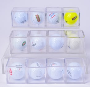 Twelve Advertising Golf Balls in Plastic Cubes