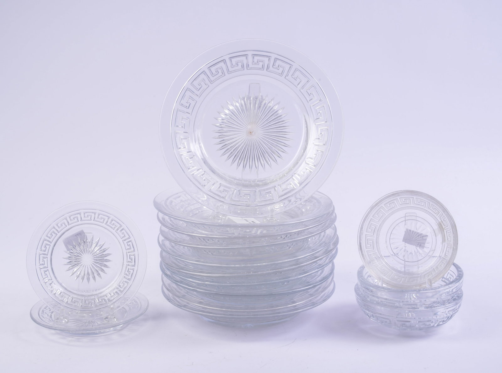 Group of Heisey Glass Greek Key Design Wares.: Ten 7.25 inch plates, a pair of berry bowls and under plates. Together with an unmarked piece. Some chips.