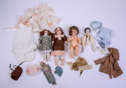 Four Porcelain Dolls and a Collection of Clothes.