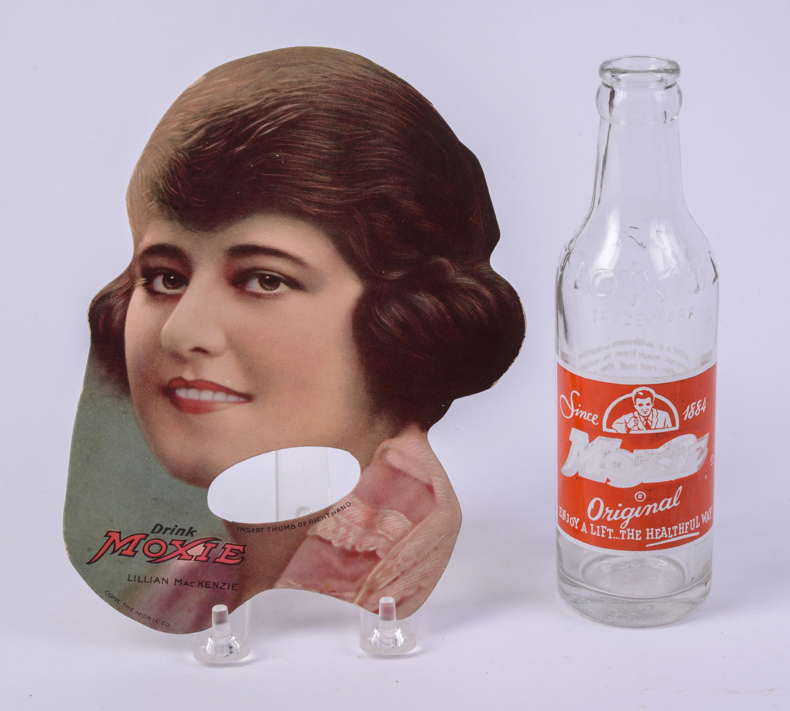 Moxie Hand Fan With Lillian Mackenzie.: 8 x 6 inches, good condition. TOgether with a moxie bottle.
