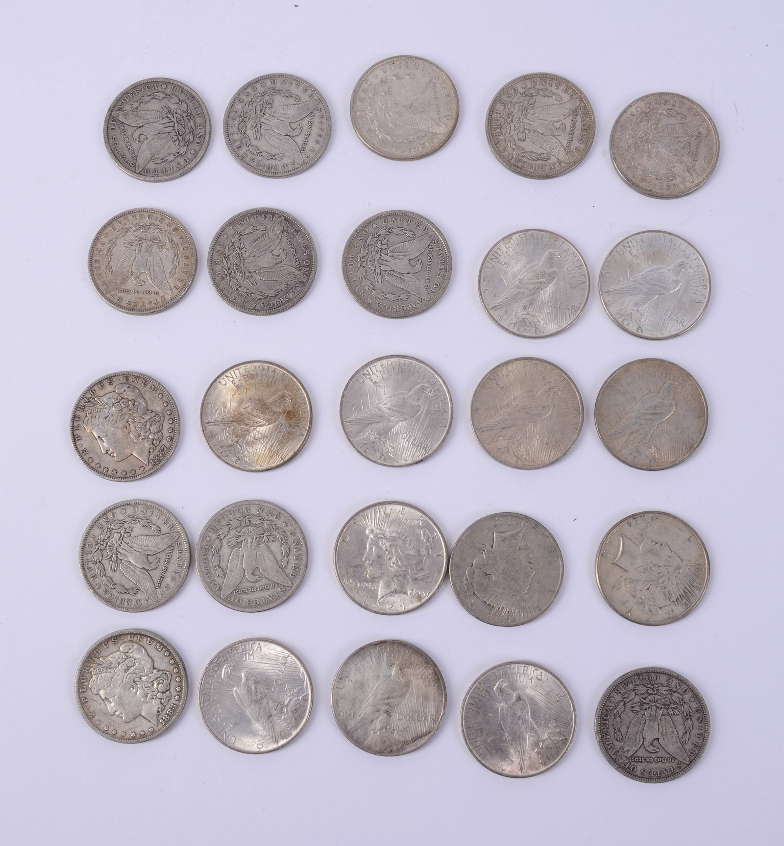 Twenty-Five Liberty Dollars.: 1881, 1883(2), 1886, 1887(3), 1890(2), 1891, 1921(3), 1923(2), 1924(10). Circulated, fair-to-good condition.