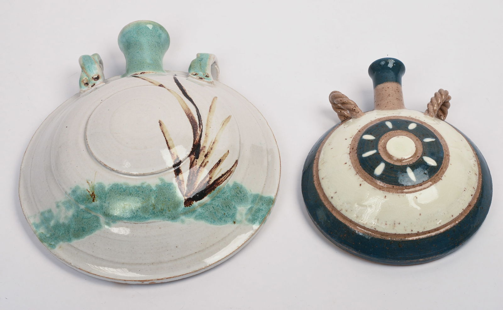 Two Decorated Pottery Wall Vases with Rope Handles by Richard Garrity.: Heights 8 and 11.5 inches.