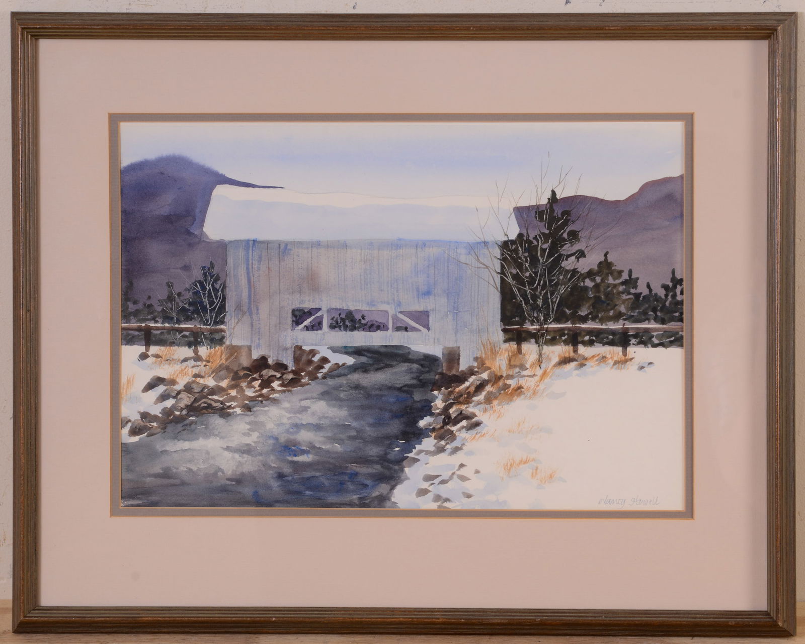 Framed Watercolor Landscape of Covered Bridge and Stream.: Signed lower right Nancy Howell. Frame 18 x 22 inches, sight 11 x 16 inches.