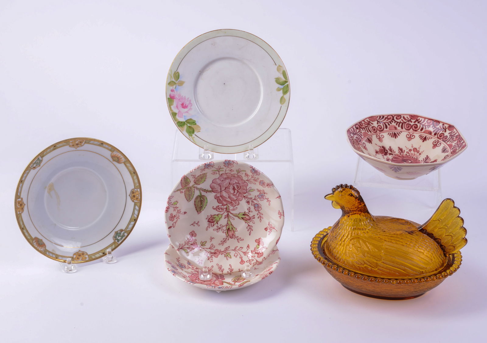 Amber Glass Covered Chicken Dish with Delft Dish and Four Porcelain Saucers.: Width of chicken dish 7 inches. Good condition.