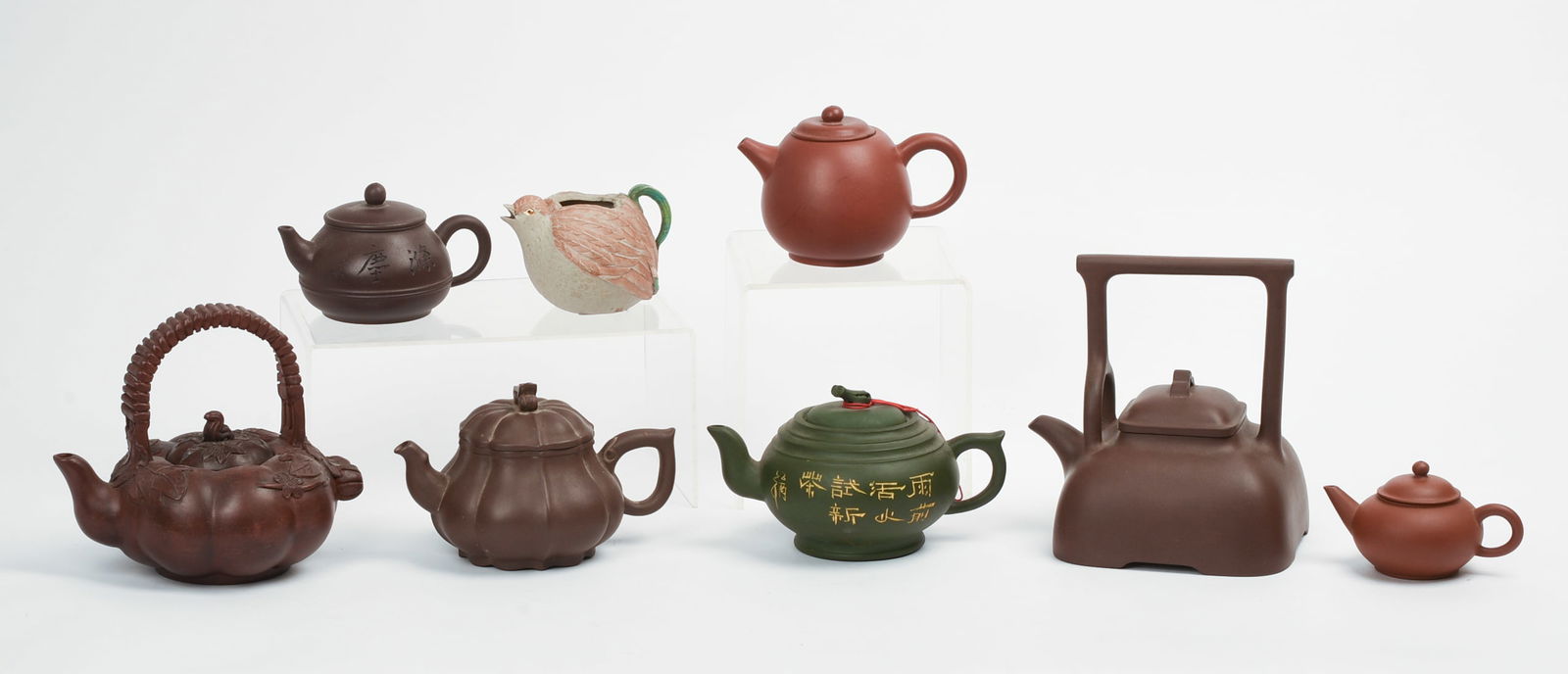 Seven Chinese Pottery Teapots with Bird Creamer.: Height of largest teapot 6 inches. Good condition.