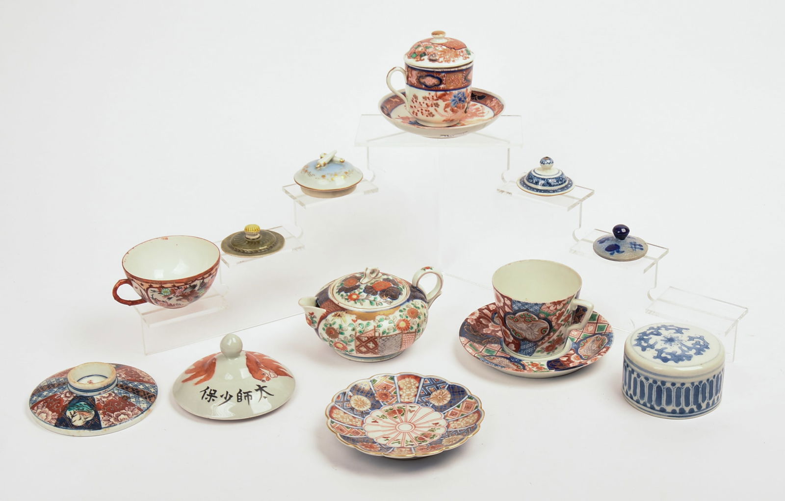 Imari Decorated Teapot and Cups and Saucers.: With 6 Chinese lids. Height of teapot 2.5 inches. Good condition.