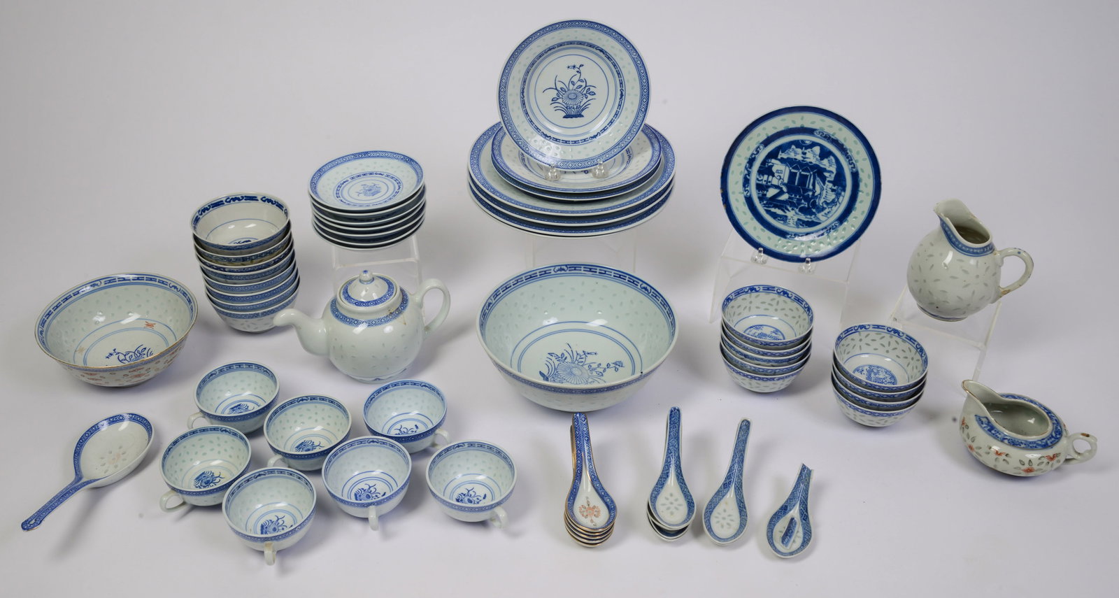 Chinese Blue and White Floral Dinner Service with Translucent Rims.: Including 3 dinner plates, 17 small bowls, 4 small plates, teapot, 2 creamers, 13 spoon rests, 2 serving bowls and 7 cups and saucers. Dinner plate diameter 10 inches. Good condition.