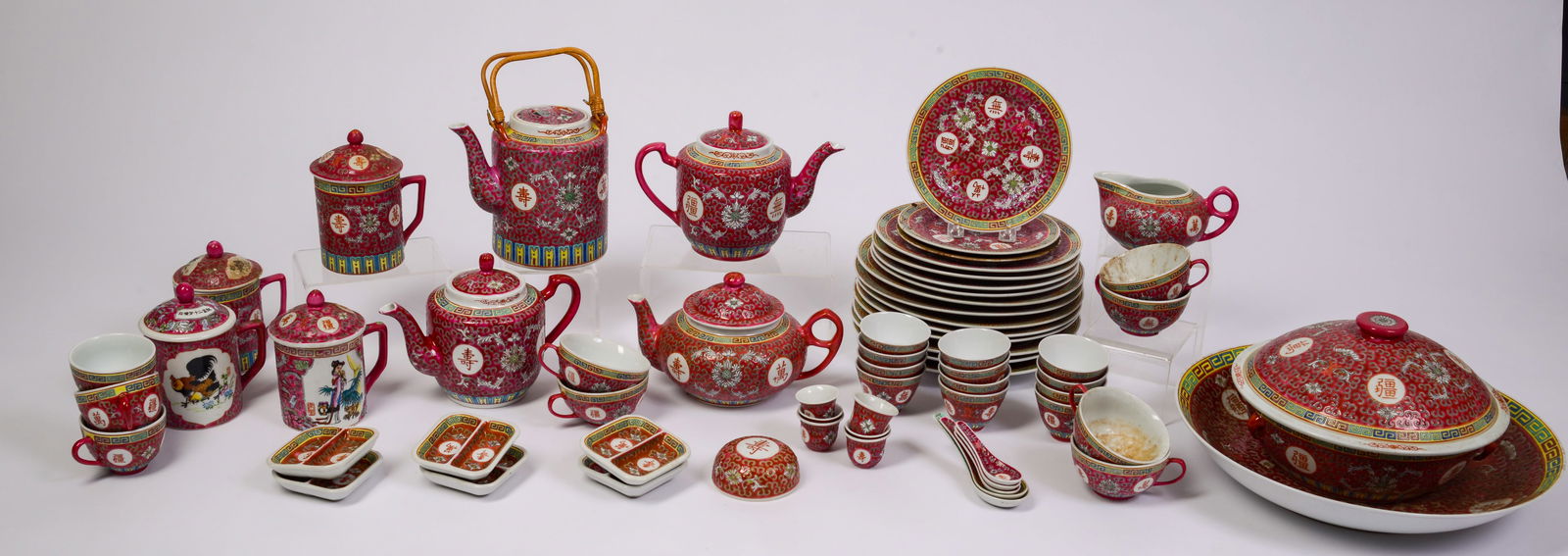 Red Ground Chinese Porcelain Dinner Service with Yellow Rims.: Including 14 dinner plates, large bowl, covered dish, 4 teapots, creamer, 4 covered mugs, 9 tea cups, 3 small plates, 6 small divided dishes, 6 thimbles, 5 spoon rests. Diameter of dinner plate 10 inc
