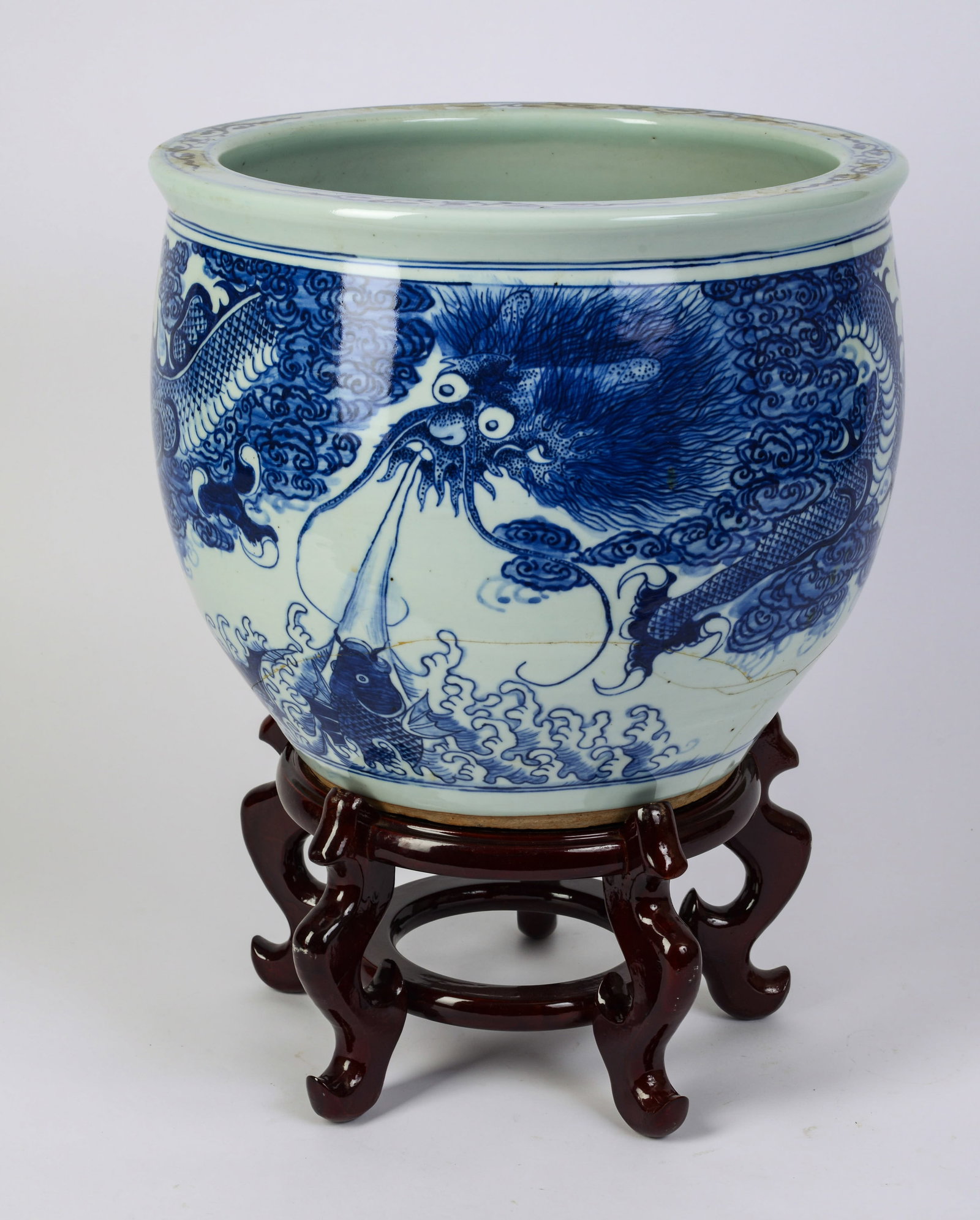 Chinese Blue and White Jardiniere and Stand.: Height of jardiniere 12 inches. Crack to base.