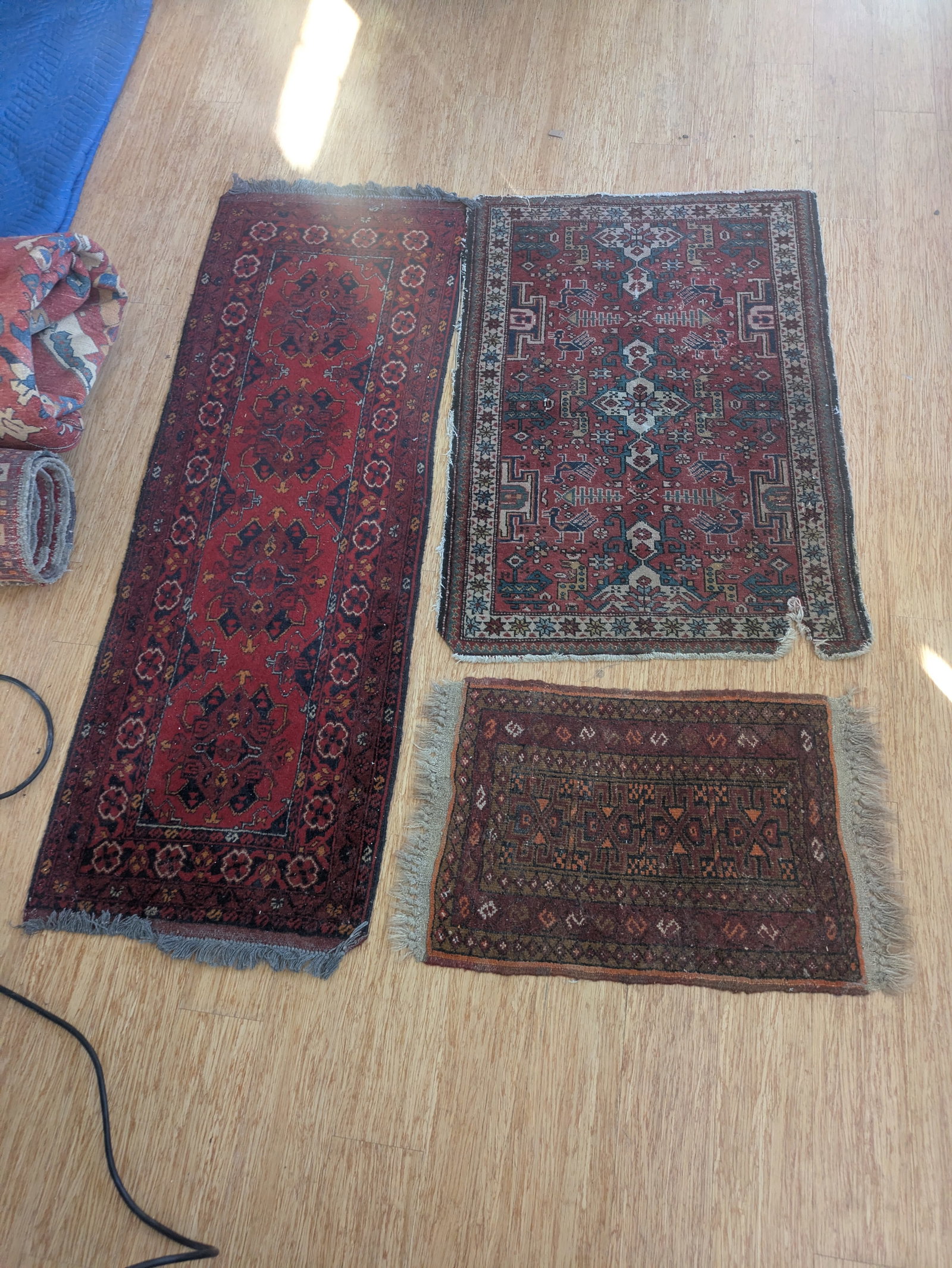 Three Small Oriental Carpets.: Runner, 5 feet by 20 inches, and two others. Some tears and stains.