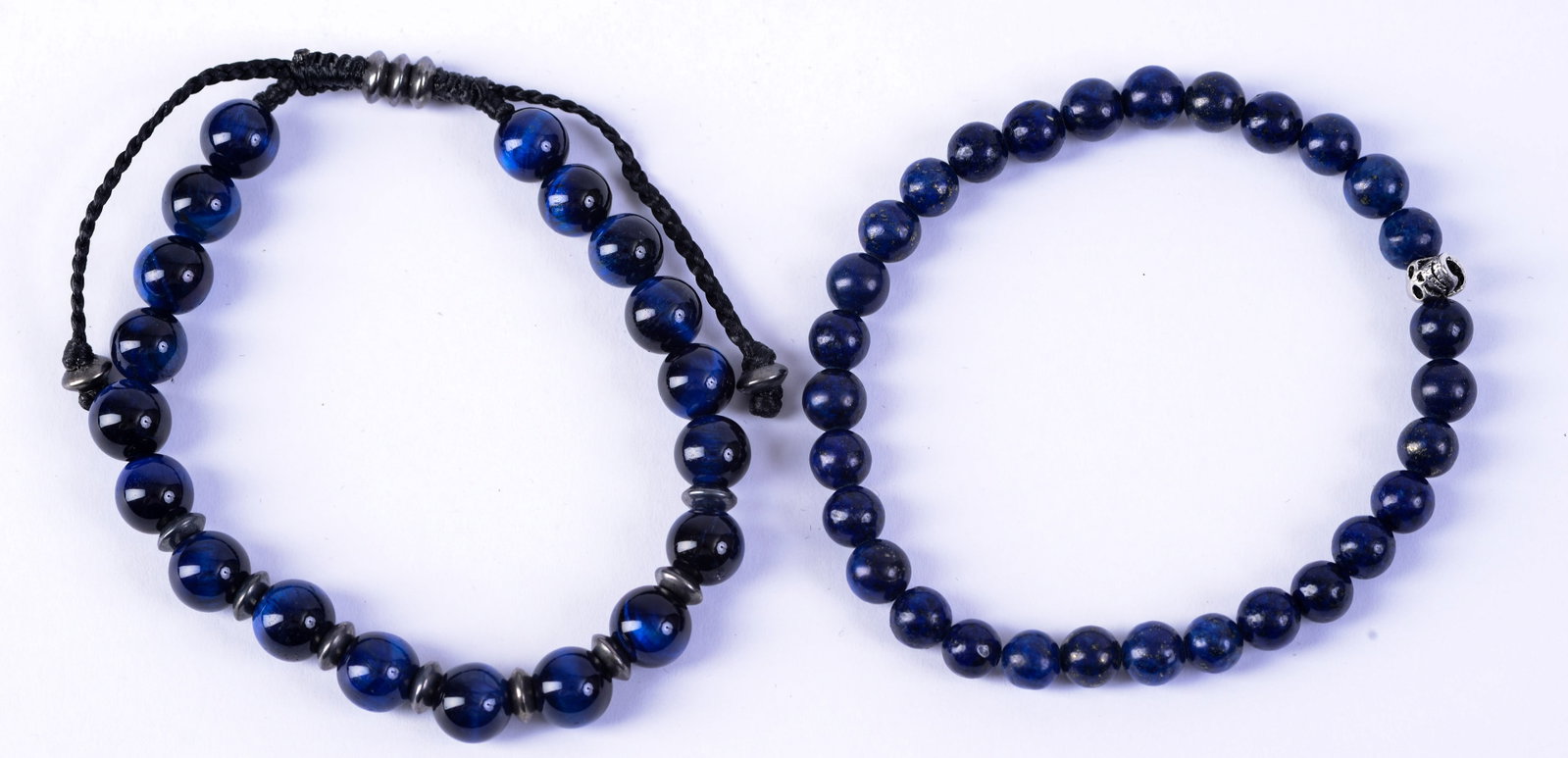 Two Beaded Bracelets.: One possibly lapis with a skull. Width of smaller 2.25 inches.