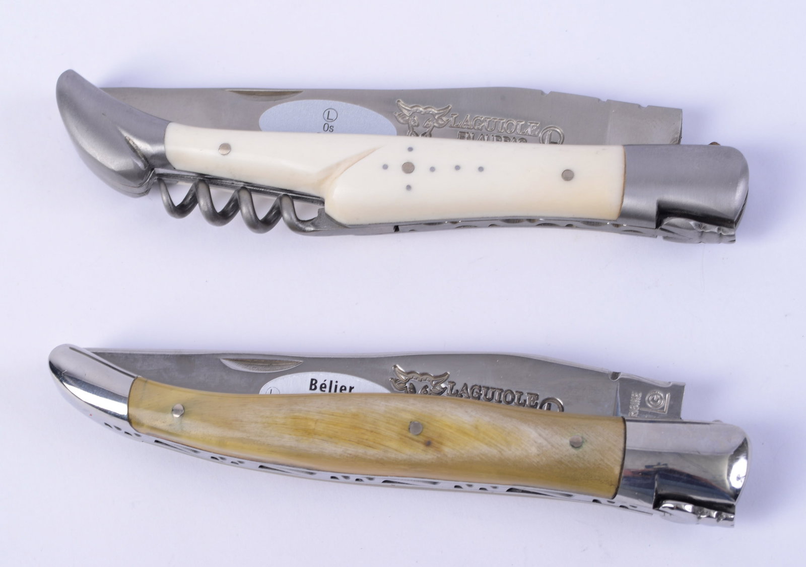 Two Laguiole en Aubrac Pocket Knives.: One with corkscrew and bone handle, other with ram's horn handle. Length 4.75 inches. Both in fairly new condition.