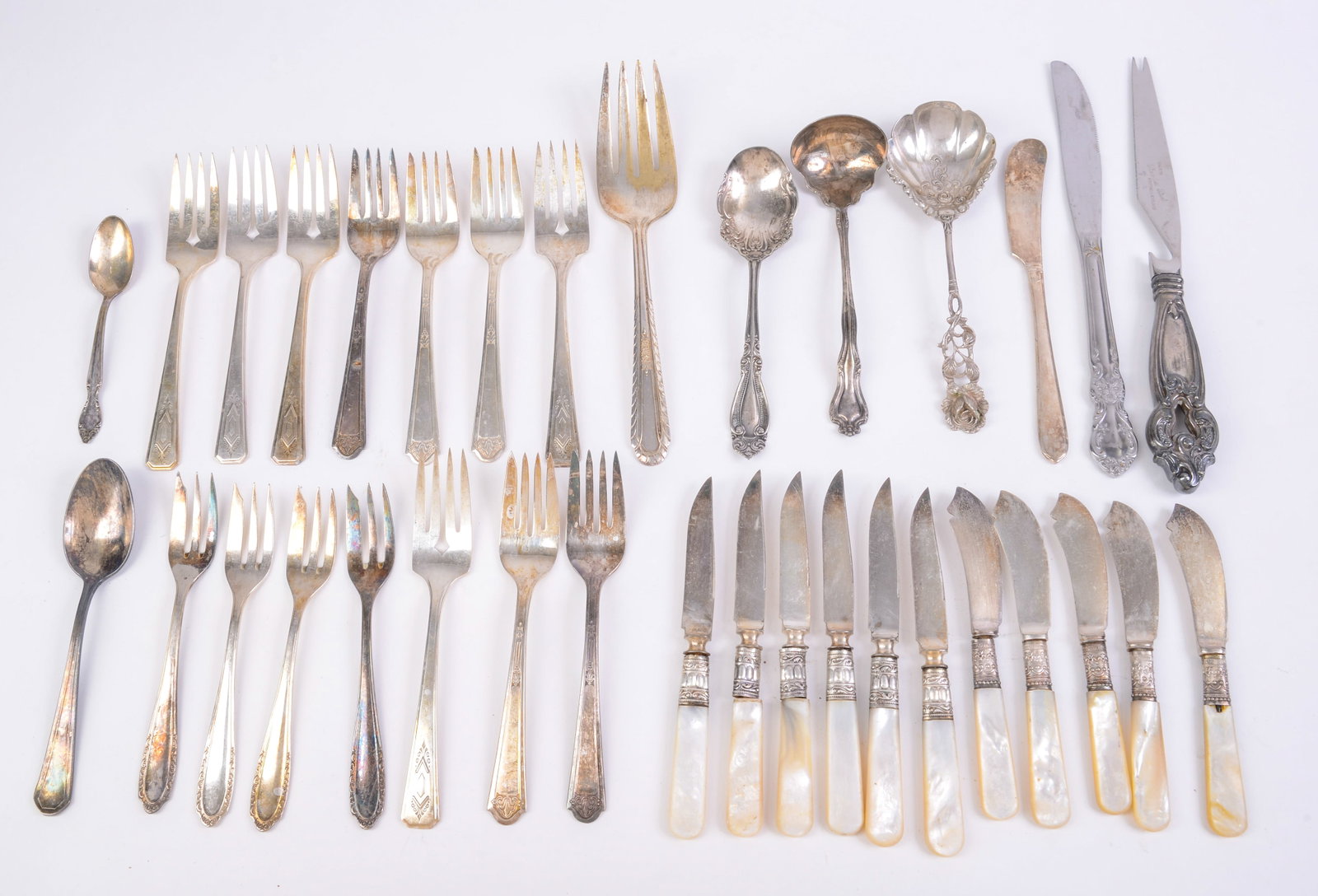 11 Small Knives with Silver and Mother of Pearl Handles: With other flatware. Knife length 6 inches.