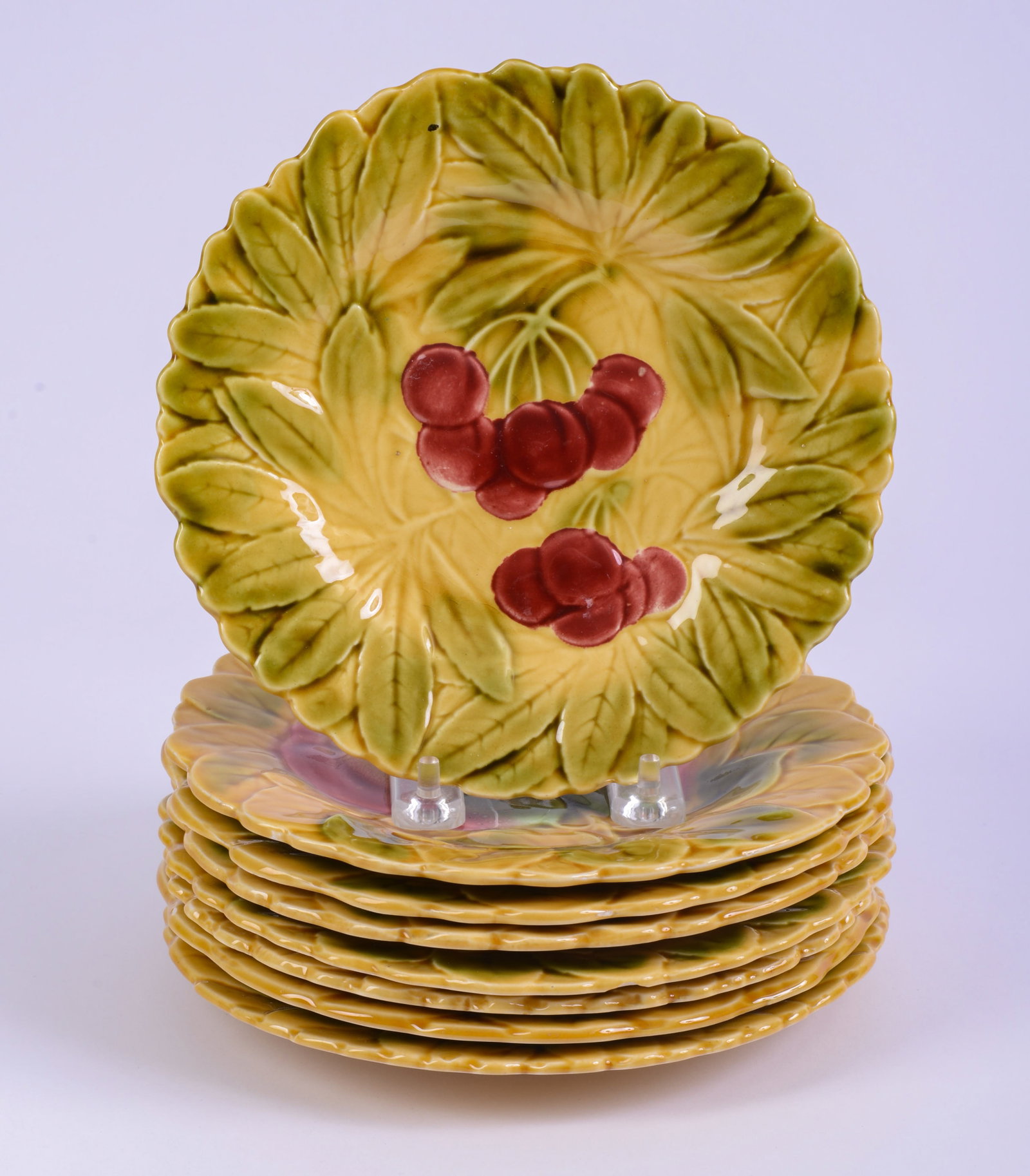 8 French Sarreguemines Fruit Decorated Dessert Plates: With leaf pattern. Diameter 7.5 inches. Some chips