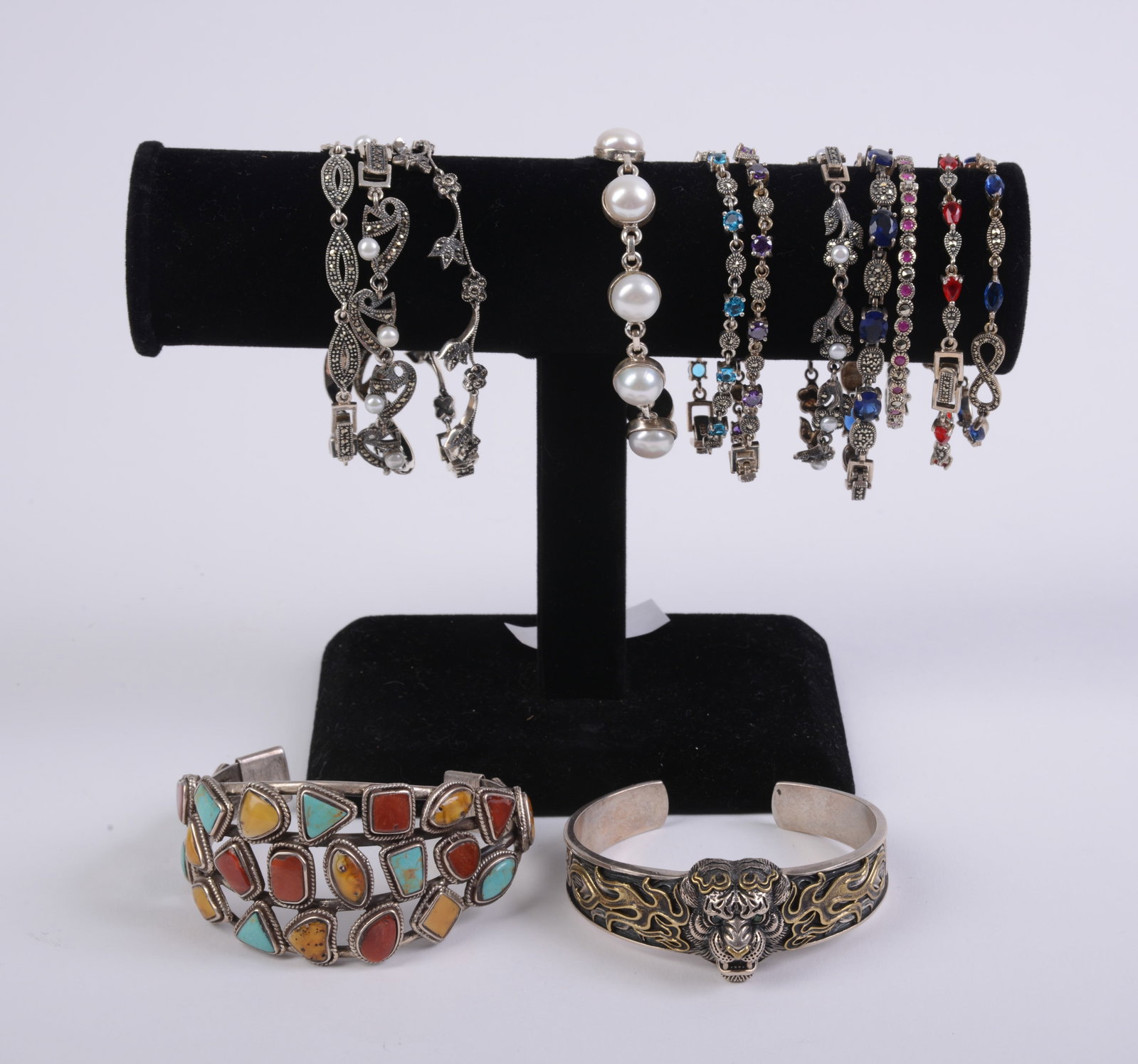 12 Costume Jewelry Bracelets.: Includes stand.