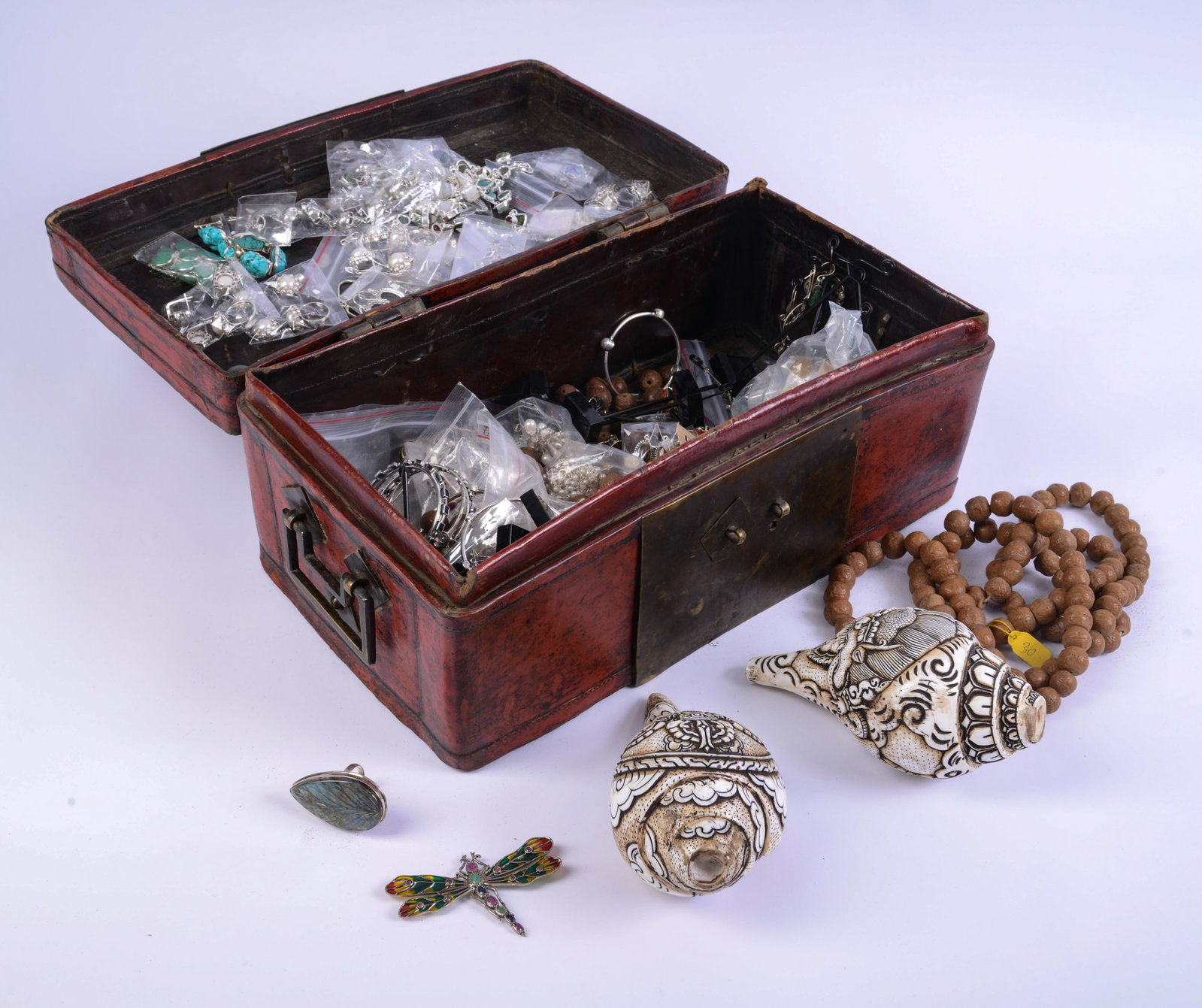Leather Box, Two Carved Shells, and a Jewelry Collection.: Box 7 x 16 x 9 inches.