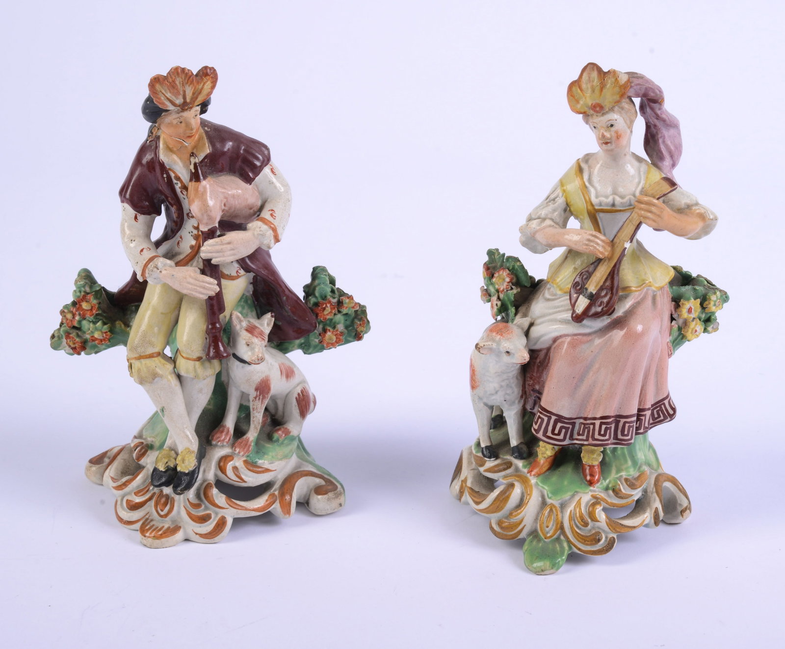 Pair of Staffordshire Bocage Figures.: Height 6 ½ inches. Crack to male figure's face.
