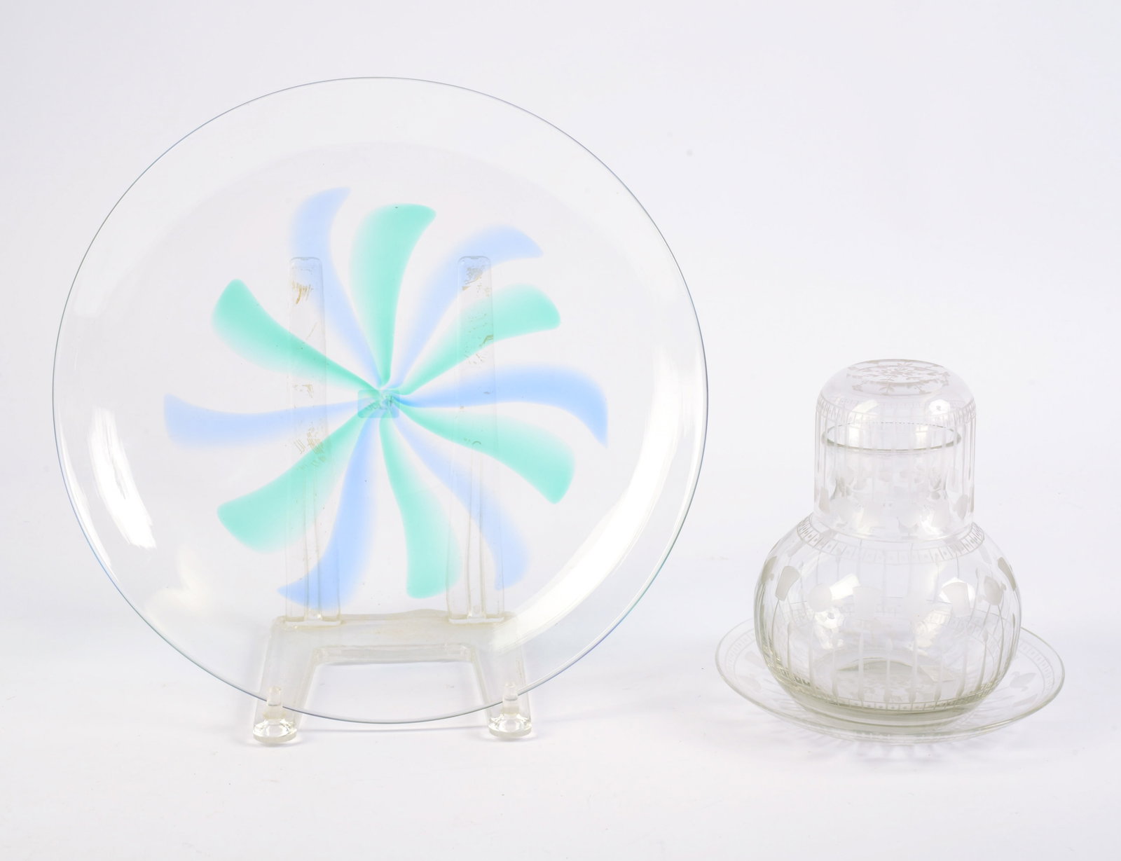 Delvaux Three Piece Etched Glass Tumble Up.: Maker mark '18 Rue Royale Paris.' Together with a blown glass plate with pinwheel design. Diameter of plate 11 ¾ inches.