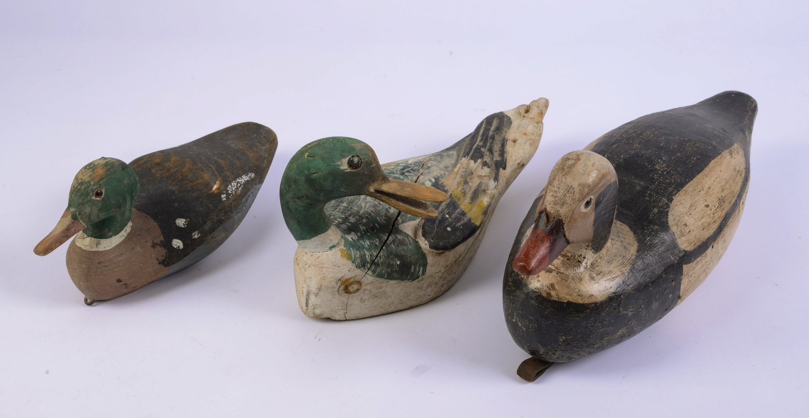 Three Carved Decoys: One signed R.W. Schaap, Portland, Oregon. Lengths 10.5, 12 and 15 inches.
