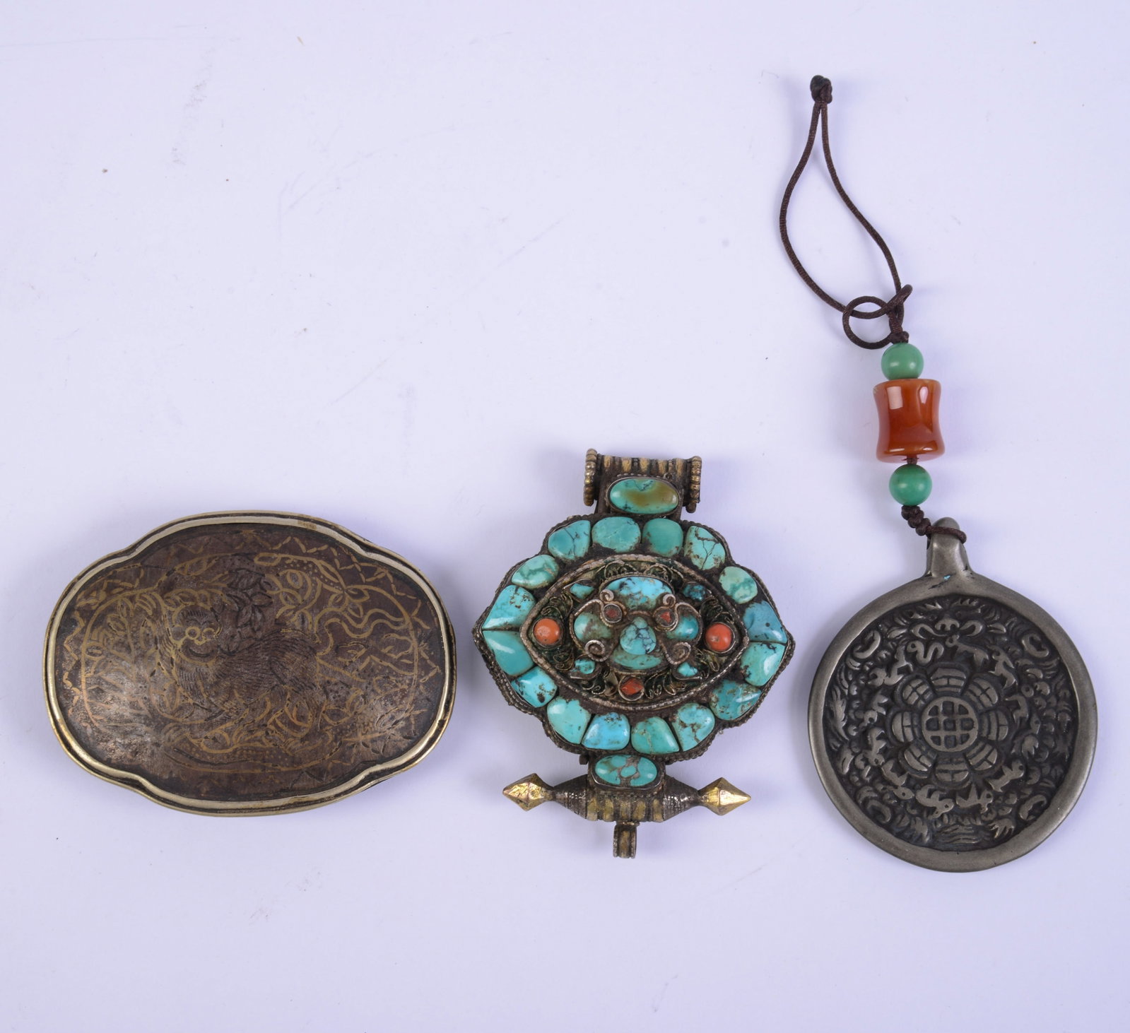 Two Tibetan Pendants and a Belt Buckle. (1 of 2)